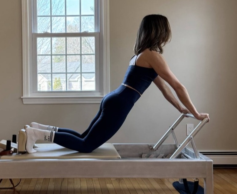 Pilates instructor guiding a private session in Millis MA
